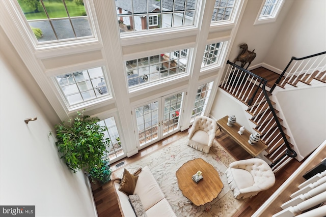2740 Hunter Mill Rd, Oakton, VA 22124 - living area with a towering ceiling, stairs, wood finished floors, and baseboards