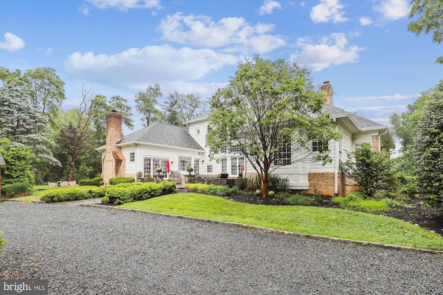 2740 Hunter Mill Rd, Oakton, VA 22124 - view of front of property with a chimney, a front lawn, brick siding, and a deck