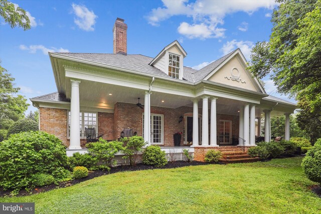 2740 Hunter Mill Rd, Oakton, VA 22124 - view of front of home featuring a front yard, a ceiling fan, a chimney, brick siding, and a porch