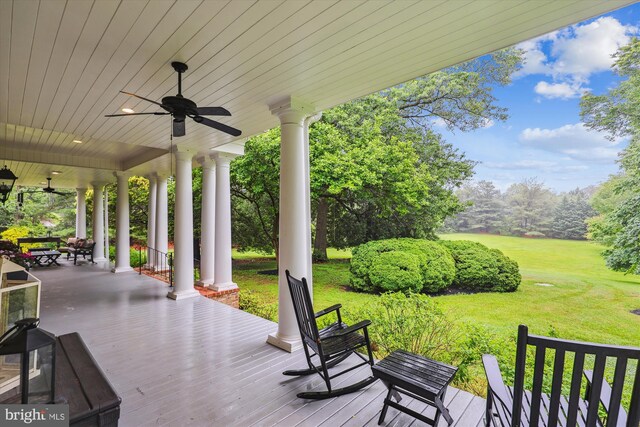 2740 Hunter Mill Rd, Oakton, VA 22124 - wooden porch with ceiling fan and a lawn