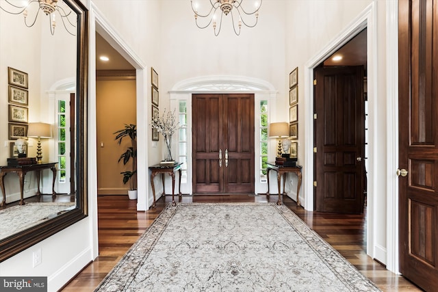 2740 Hunter Mill Rd, Oakton, VA 22124 - foyer entrance with a chandelier, a towering ceiling, dark wood-style flooring, plenty of natural light, and baseboards