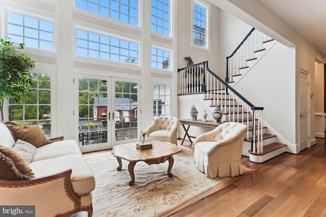 2740 Hunter Mill Rd, Oakton, VA 22124 - living room with french doors, wood finished floors, a high ceiling, stairs, and baseboards