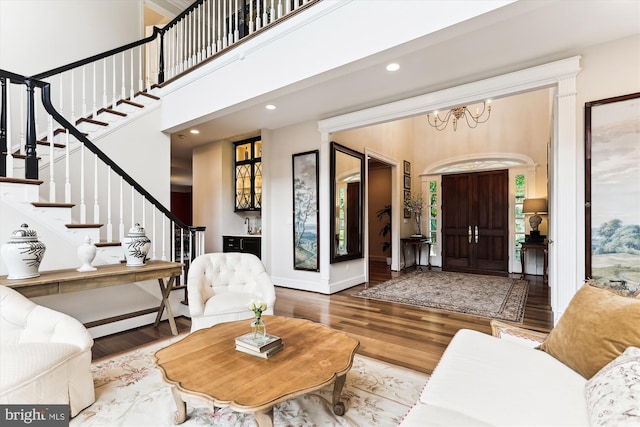 2740 Hunter Mill Rd, Oakton, VA 22124 - living area featuring stairway, wood finished floors, a chandelier, recessed lighting, and a high ceiling