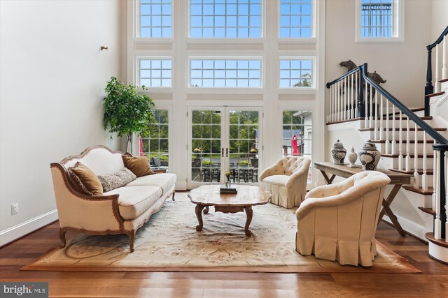 2740 Hunter Mill Rd, Oakton, VA 22124 - living area featuring a towering ceiling, baseboards, french doors, stairs, and wood finished floors