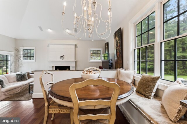 2740 Hunter Mill Rd, Oakton, VA 22124 - dining space with wood finished floors, a fireplace, a chandelier, and baseboards