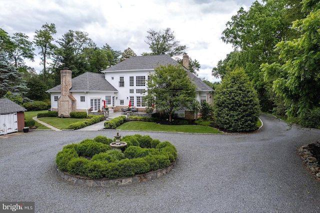 2740 Hunter Mill Rd, Oakton, VA 22124 - view of front of house featuring curved driveway, french doors, a chimney, and a front lawn