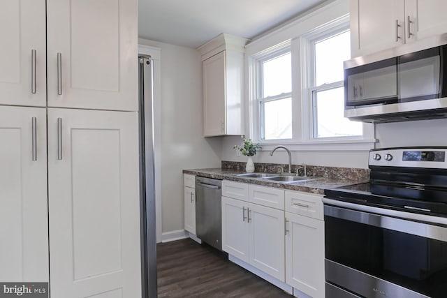 147 N Spruce St, Elizabethtown, PA 17022 - kitchen featuring stainless steel appliances, a sink, white cabinets, dark countertops, and baseboards