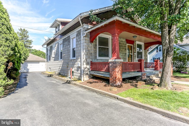 147 N Spruce St, Elizabethtown, PA 17022 - view of front facade with covered porch, an outbuilding, a garage, and stone siding