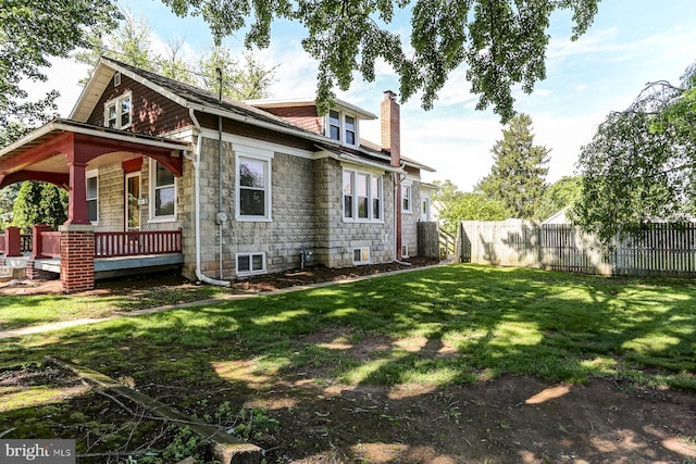 147 N Spruce St, Elizabethtown, PA 17022 - rear view of property with a chimney, stone siding, and covered porch