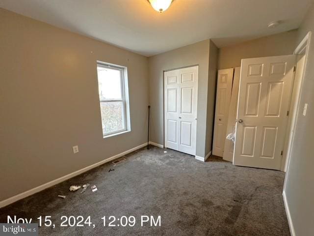 2468 Greenmount Ave, Baltimore, MD 21218 - unfurnished bedroom with carpet floors, baseboards, and a closet