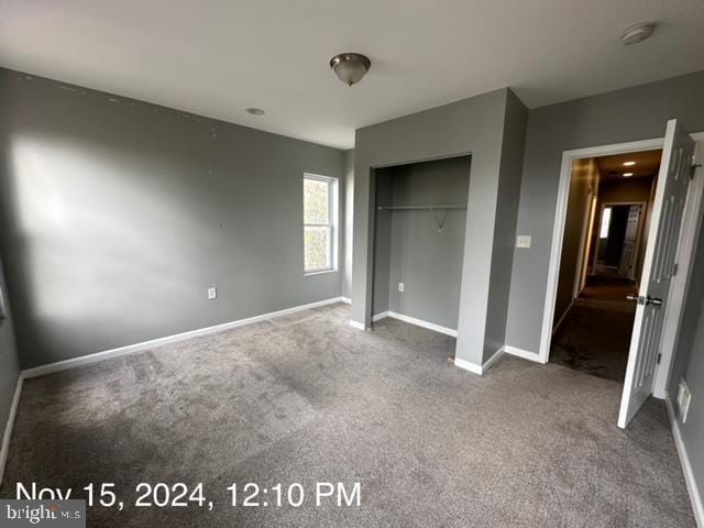 2468 Greenmount Ave, Baltimore, MD 21218 - unfurnished bedroom with dark colored carpet, baseboards, and a closet