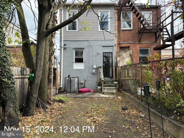2468 Greenmount Ave, Baltimore, MD 21218 - rear view of property featuring brick siding, entry steps, and central air condition unit