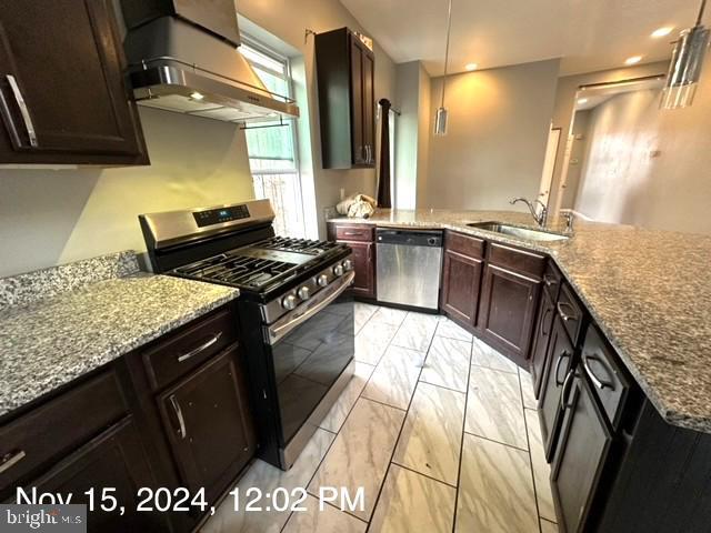 2468 Greenmount Ave, Baltimore, MD 21218 - kitchen featuring appliances with stainless steel finishes, ventilation hood, a sink, a peninsula, and light stone countertops