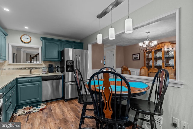 3778 Westhampton Dr, Philadelphia, PA 19154 - kitchen with stainless steel appliances, a sink, light countertops, a chandelier, and dark wood-style flooring