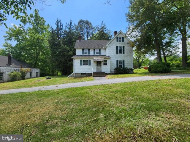 6428 Quantico Rd, Quantico, MD 21856 - traditional-style home featuring a front lawn and a chimney