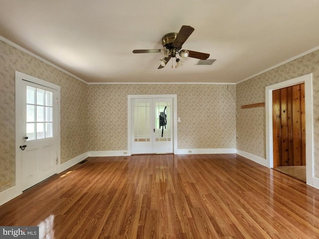 6428 Quantico Rd, Quantico, MD 21856 - empty room with wood finished floors, crown molding, ceiling fan, wallpapered walls, and french doors