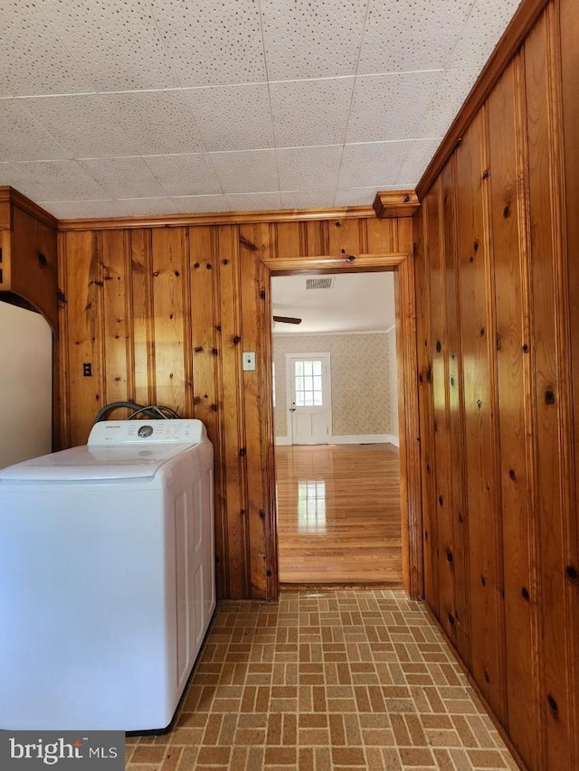 6428 Quantico Rd, Quantico, MD 21856 - laundry room featuring washer / clothes dryer, brick patterned floors, wooden walls, and arched walkways