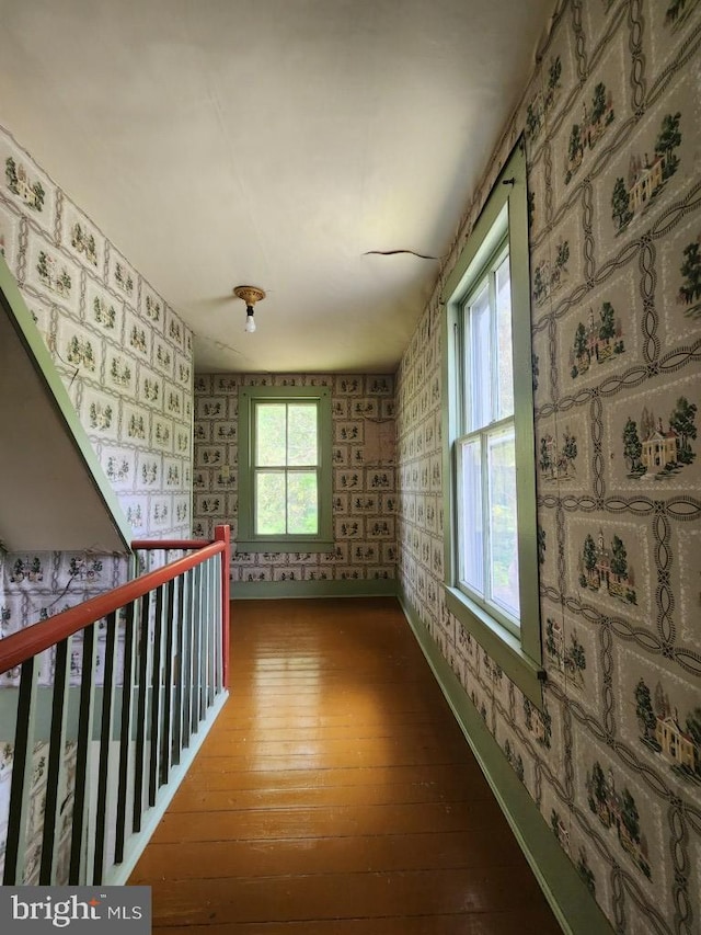 6428 Quantico Rd, Quantico, MD 21856 - corridor featuring wallpapered walls, wood-type flooring, an upstairs landing, and baseboards
