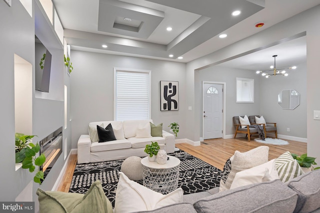 5300 Merceron Ave, Baltimore, MD 21207 - living area featuring light wood finished floors, baseboards, recessed lighting, a tray ceiling, and a chandelier
