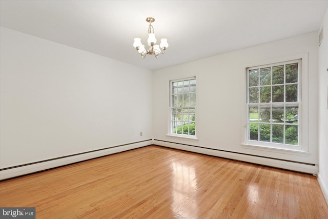 425 Wister Rd, Wynnewood, PA 19096 - empty room featuring a baseboard radiator, a chandelier, and wood finished floors