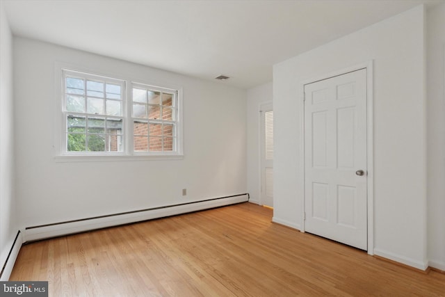 425 Wister Rd, Wynnewood, PA 19096 - unfurnished bedroom featuring light wood-type flooring, a baseboard heating unit, and baseboards