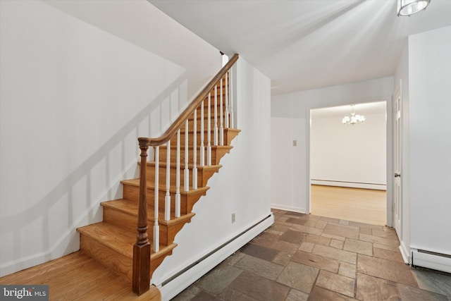 425 Wister Rd, Wynnewood, PA 19096 - staircase with baseboard heating, a chandelier, stone tile flooring, and baseboards