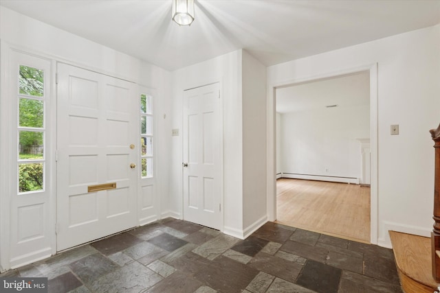 425 Wister Rd, Wynnewood, PA 19096 - foyer entrance with stone tile floors, a baseboard heating unit, and baseboards