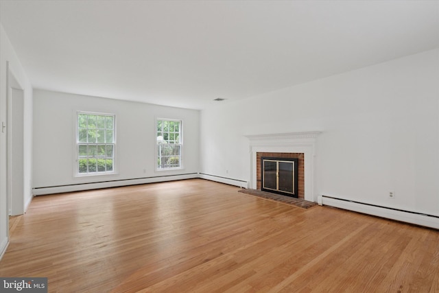 425 Wister Rd, Wynnewood, PA 19096 - unfurnished living room with light wood finished floors, a brick fireplace, and baseboard heating