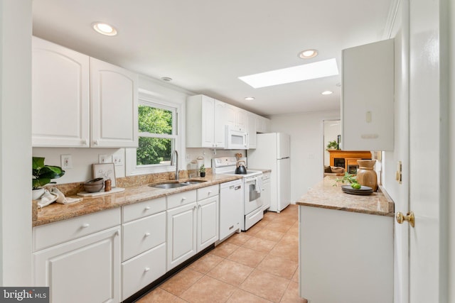 26140 Mullinix Mill Rd, Mount Airy, MD 21771 - kitchen featuring a sink, white appliances, a skylight, white cabinetry, and light tile patterned flooring