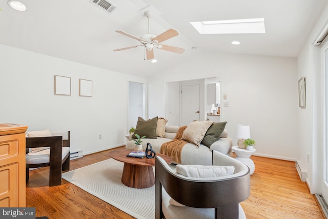 26140 Mullinix Mill Rd, Mount Airy, MD 21771 - living area with a baseboard radiator, a ceiling fan, lofted ceiling, a skylight, and light wood-style floors