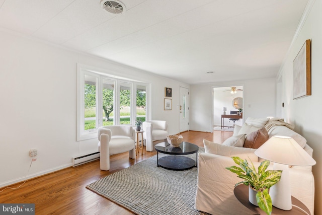 26140 Mullinix Mill Rd, Mount Airy, MD 21771 - living room featuring a baseboard radiator, wood finished floors, and baseboards