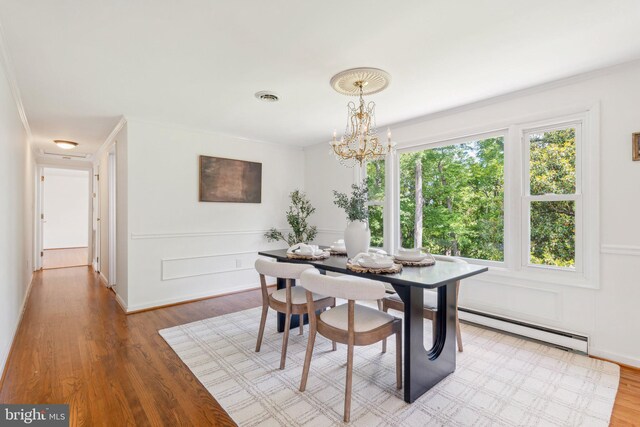 26140 Mullinix Mill Rd, Mount Airy, MD 21771 - dining space featuring a baseboard radiator, a chandelier, and light wood-style flooring