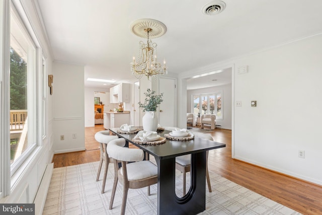 26140 Mullinix Mill Rd, Mount Airy, MD 21771 - dining space featuring a chandelier, light wood finished floors, ornamental molding, and baseboards