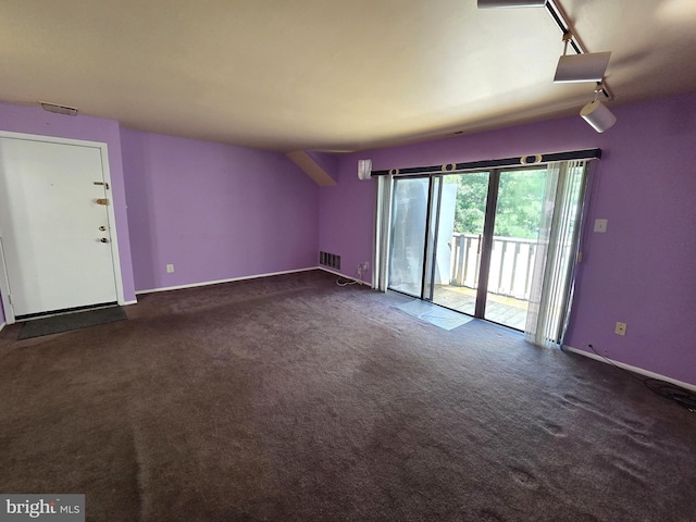 2704 Adams Ct, North Wales, PA 19454 - unfurnished living room featuring dark colored carpet, baseboards, and track lighting