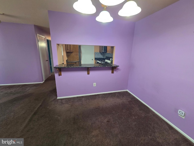 2704 Adams Ct, North Wales, PA 19454 - kitchen featuring range with gas stovetop, dark colored carpet, a kitchen bar, black microwave, and baseboards