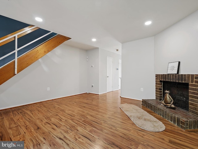1806 Bryant St NE Unit 1806, Washington, DC 20018 - unfurnished living room featuring wood finished floors, a brick fireplace, recessed lighting, and baseboards