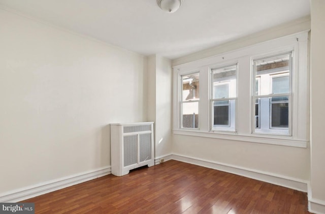 527 Brookside Ave, Lansdowne, PA 19050 - unfurnished room featuring dark wood-style floors, plenty of natural light, baseboards, and radiator
