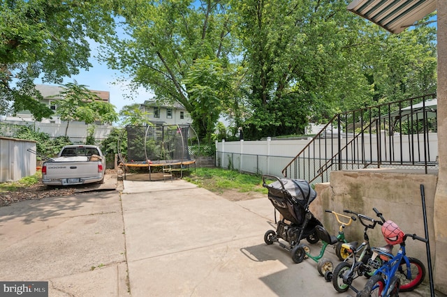 527 Brookside Ave, Lansdowne, PA 19050 - fenced backyard featuring a trampoline and a patio area