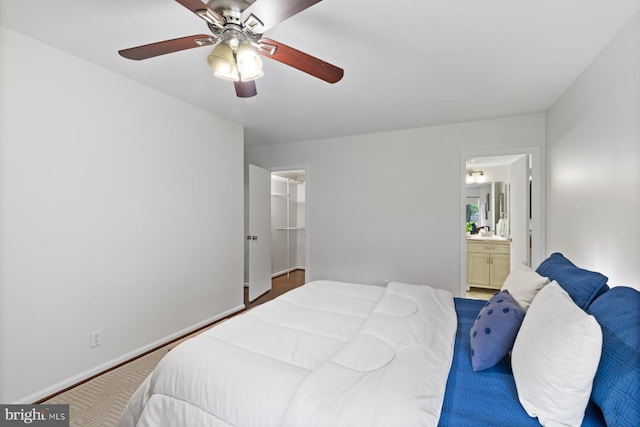 29 Stonehenge Cir Unit 6, Pikesville, MD 21208 - bedroom featuring ensuite bathroom, a ceiling fan, and baseboards
