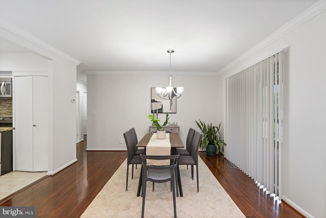 29 Stonehenge Cir Unit 6, Pikesville, MD 21208 - dining space featuring wood finished floors, a chandelier, crown molding, and baseboards