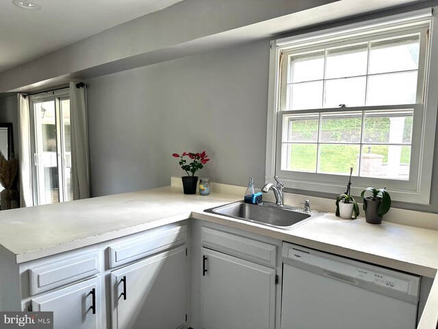 15709 Presswick Ln, Bowie, MD 20716 - kitchen featuring white dishwasher, a sink, light countertops, a peninsula, and white cabinets