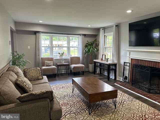15709 Presswick Ln, Bowie, MD 20716 - living area featuring wood finished floors, healthy amount of natural light, a brick fireplace, and recessed lighting