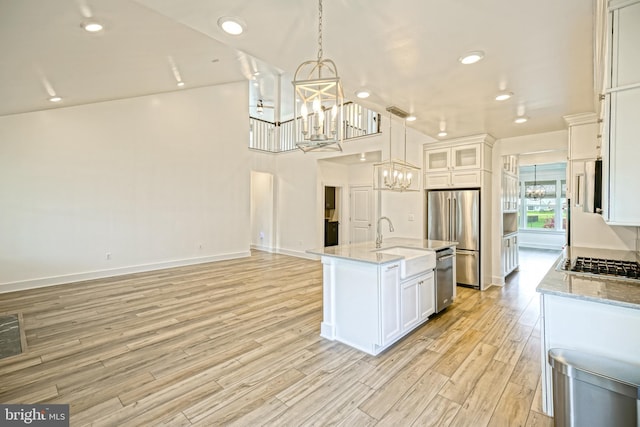 35024 Black Walnut Dr, Lewes, DE 19958 - kitchen with a chandelier, appliances with stainless steel finishes, a sink, light wood-style flooring, and recessed lighting