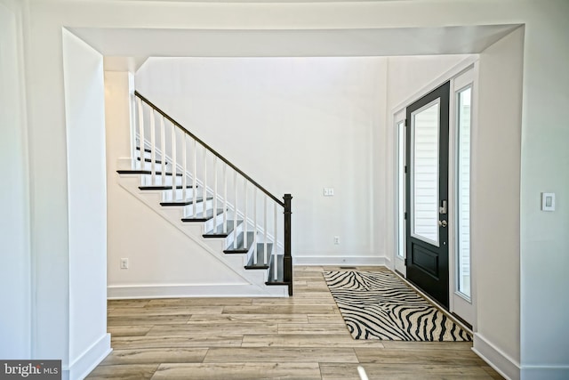 35024 Black Walnut Dr, Lewes, DE 19958 - foyer featuring wood finished floors, baseboards, stairway, and healthy amount of natural light