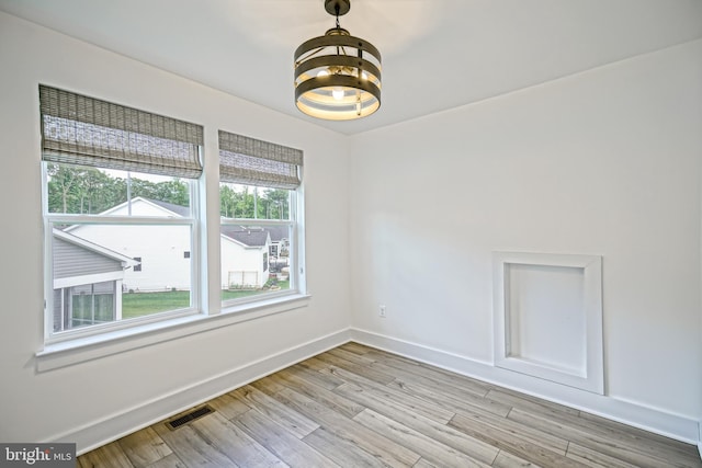 35024 Black Walnut Dr, Lewes, DE 19958 - empty room with a chandelier, baseboards, and light wood-style flooring