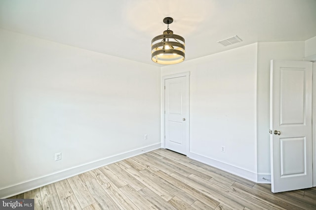 35024 Black Walnut Dr, Lewes, DE 19958 - empty room with a chandelier, wood finished floors, and baseboards