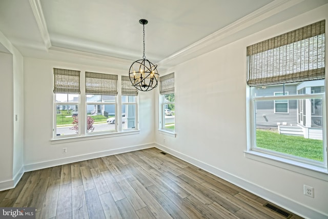35024 Black Walnut Dr, Lewes, DE 19958 - unfurnished room with a chandelier, wood finished floors, baseboards, a tray ceiling, and ornamental molding
