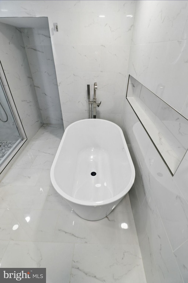 7746 16th St NW, Washington, DC 20012 - full bathroom with a freestanding tub, marble tiled flooring, and tile walls