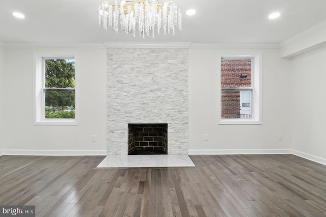 7746 16th St NW, Washington, DC 20012 - unfurnished living room with a chandelier, wood finished floors, crown molding, a fireplace with flush hearth, and baseboards