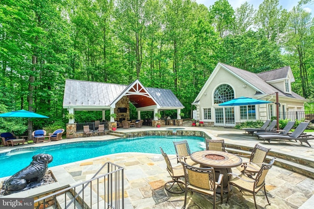 5026 Huntwood Manor Dr, Fairfax, VA 22030 - view of pool featuring a storage structure, an outdoor structure, a patio, an outdoor fire pit, and a pool with connected hot tub